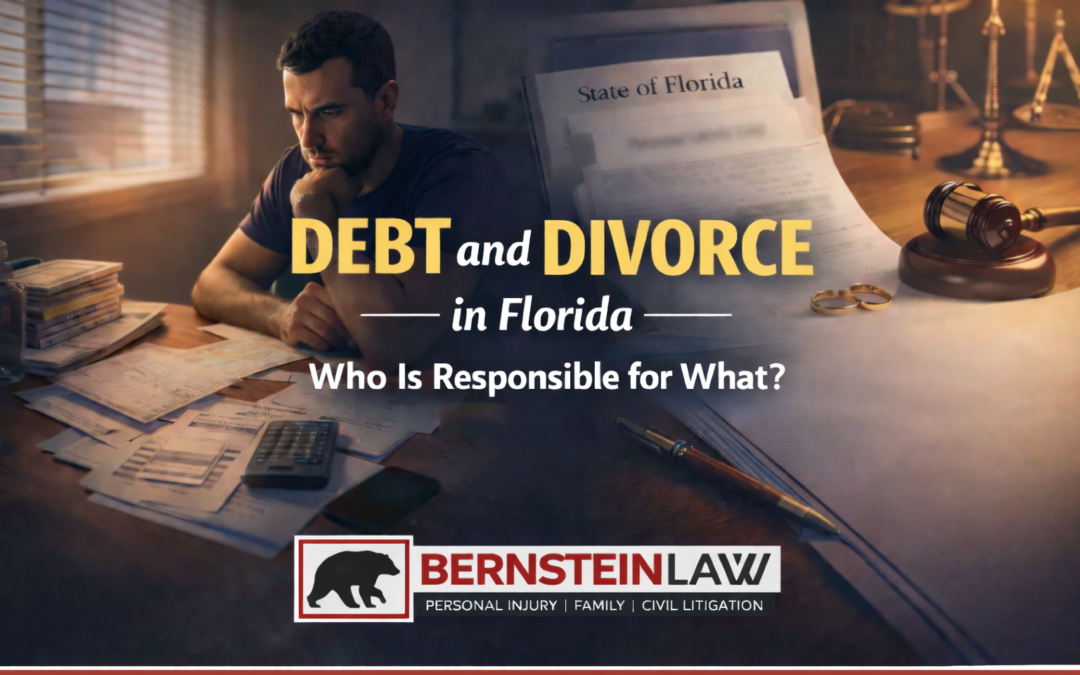 A worried man sits at a desk covered in bills and paperwork, symbolizing financial stress during divorce.